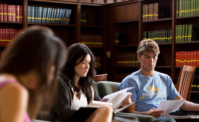 one male and two female students in library