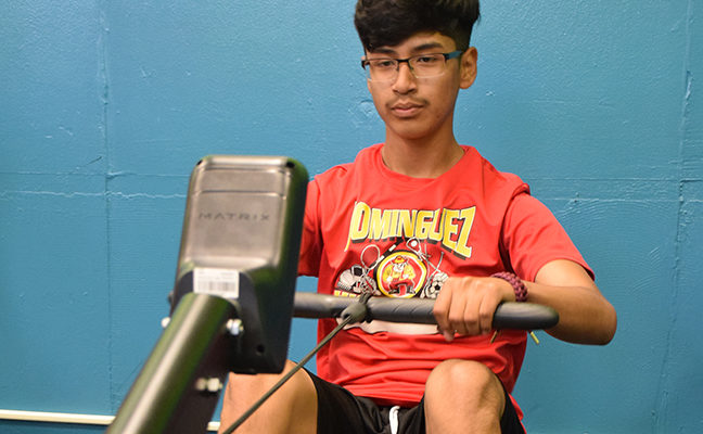 Male student on a rowing machine