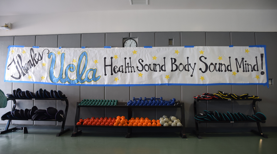 Gymnasium wall with handmade sign thanking UCLA Health.