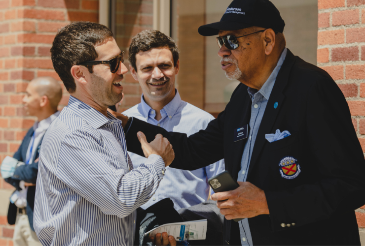 UCLA Anderson professor emeritus and alumnus sharing a warm moment, reflecting the lasting bond between faculty and the Anderson community.