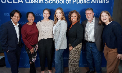 A group of students standing in front of a sign that reads Luskin School of Public Affairs