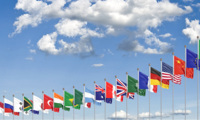 Various flags of the world arranged on flag poles.
