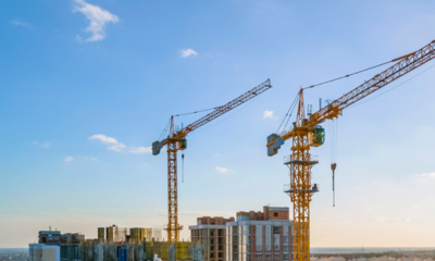 Two cranes assisting in construction of a building.